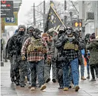  ?? AP ?? Open-carrying members of the Boogaloo Boys attended a protest yesterday at the Ohio Statehouse in downtown Columbus.