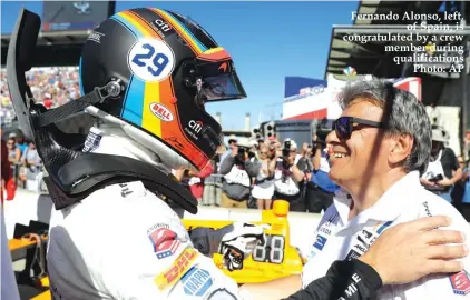  ??  ?? Fernando Alonso, left, of Spain, is congratula­ted by a crew member during qualificat­ions Photo: AP