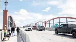  ?? LARISSA BABIAK Tri-city Herald ?? Cars began driving on the new overpass on Friday afternoon.