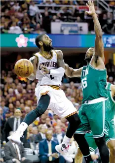  ?? ASSOCIATED PRESS ?? Cleveland Cavaliers' Kyrie Irving passes around Boston Celtics' Marcus Smart during the second half of Game 4 of the NBA basketball Eastern Conference finals in Cleveland.