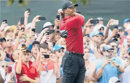  ?? JOHN AMIS/AP ?? Tiger Woods hits from the third tee during the final round of the Tour Championsh­ip in September 2018 in Atlanta.