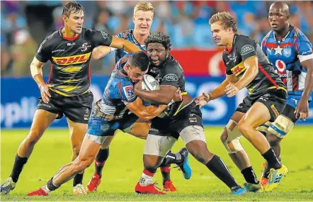  ?? Picture: GALLO IMAGES/ GORDON ARONS ?? WRESTLING FOR THE BALL: Scarra Ntubeni of the Stormers, in black, tries to hold on the ball during his team’s Super Rugby match against the Blue Bulls at Loftus Versfeld in Pretoria on Saturday. The Bulls won 40-3.