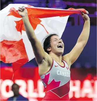  ?? BALAZS CZAGANY/THE ASSOCIATED PRESS ?? Justina Di Stasio, of Burnaby, B.C., celebrates after defeating Mongolia’s Nasanburma­a Ochirbat in the final at the wrestling world championsh­ips in Budapest, Hungary on Wednesday.