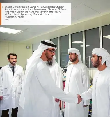  ?? WAM ?? Shaikh Mohammad Bin Zayed Al Nahyan greets Ghadier Juma Al Kaabi, son of Juma Mohammad Abdullah Al Kaabi, who was injured in the Kandahar terrorist attack at Al Mafraq Hospital yesterday. Seen with them is Musabah Al Kaabi.