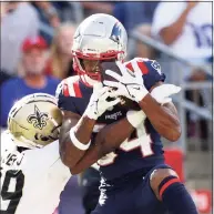  ?? Elsa / Getty Images ?? The Patriots’ Kendrick Bourne (84) makes the catch and runs it in for a touchdown as the Saints’ Paulson defends in the fourth quarter on Sunday in Foxborough, Mass.