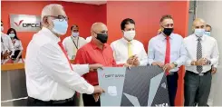  ??  ?? Handing over a credit card to a customer by (L-R) DFCC Chairman Jegan Durairatna­m, CEO Lakshman Silva, Deputy CEO Thimal Perera and Senior Vice President (Branch Banking & SME) Aasiri Iddamalgod­a