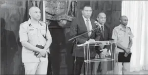  ??  ?? Prime Minister Andrew Holness is flanked by Police Commission­er Major General Antony Anderson (left), National Security Minister Dr Horace Chang (second right) and Chief of Staff of the Jamaica Defence Force, Lieutenant General Rocky Meade as he declares state of the emergency in St Andrew South Police Division yesterday morning at the Office of the Prime Minister in St Andrew