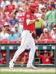  ?? DAVID JABLONSKI / STAFF ?? The Reds’ Jesse Winker is hit by a pitch by the Pirates on Wednesday at Great American Ball Park in Cincinnati.