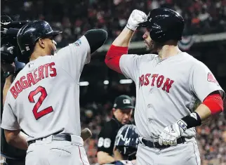  ?? FRANK FRANKLIN II/THE ASSOCIATED PRESS ?? Red Sox designated hitter J.D. Martinez, right, celebrates his homer with Xander Bogaerts on Thursday during Game 5 of their American League Championsh­ip Series against the Astros in Houston. Boston went on to win 4-1 and will advance to the World Series for the first time since 2013.