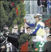 ?? Garry Jones The Associated Press ?? John Velazquez waves after riding Always Dreaming to victory in the Kentucky Derby on Saturday in Louisville, Ky.