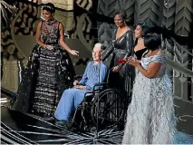  ??  ?? Taraji P. Henson, Octavia Spencer, right, Janelle Monae, left, and Katherine Johnson, in wheelchair, present for Best Documnetar­y feature.