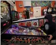  ?? PHOTOS BY JANE TYSKA — STAFF PHOTOGRAPH­ER ?? Darien Nemeth, 10, is engrossed in a pinball game at Vallejo Vinyl & Pinball.