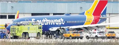  ??  ?? The damaged jet sits on the runway at Philadelph­ia Internatio­nal Airport after the incident on Tuesday
