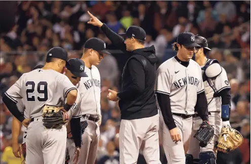  ?? Winslow Townson / Getty Images ?? Yankees manager Aaron Boone takes out Gerrit Cole, right, against the Boston Red Sox during the third inning of the American League Wild Card game at Fenway Park on Tuesday in Boston.