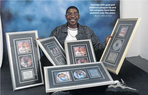  ?? / MOTLAPELE TAU ?? Tshanda with gold and platinum plaques he and his company have been awarded over the years.