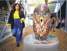  ?? ?? School counselor Florence Alabanza-de la Cruz walks by one of the mosaic art installati­ons at Normal Heights Elementary.