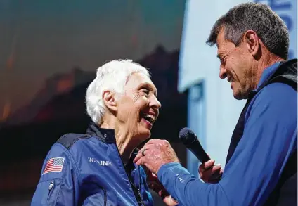  ?? Tony Gutierrez / Associated Press ?? Wally Funk is given the Blue Origin-made astronaut pin — not one from the Federal Aviation Administra­tion — from former NASA astronaut Jeff Ashby, who now works with Blue Origin, during a New Shepard post-launch briefing near Van Horn in July.