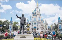 ?? ?? The “Partners” statue sits in front of Cinderella’s Castle at Disney World’s Magic Kingdom in Orlando, Florida. ALLIE GOULDING/TAMPA BAY TIMES 2019