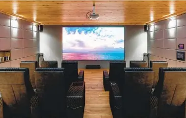  ?? GETTY IMAGES ?? Theater-style seating turns a TV room into a private home cinema.