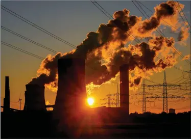  ?? (AP/Michael Probst) ?? Fumes pour out of the chimneys of a coal-fired power station earlier this month in Niederauss­em, Germany.