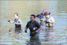  ?? SUBMITTED PHOTO ?? Hill School students wade out of the Schuylkill River at Towpath Park in East Coventry after collecting water samples.