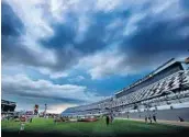  ?? JOE BURBANK/STAFF PHOTOGRAPH­ER ?? Storm clouds gather over Daytona Internatio­nal Speedway before Friday’s Xfinity series Firecracke­r 250 race.