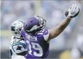  ?? BOB LEVERONE/ASSOCIATED PRESS ?? Minnesota Vikings’ Adam Thielen makes a leaping catch against Carolina Panthers’ defender Robert McClain during NFL action Sunday in Charlotte, N.C. The Vikes were 22-10 winners.