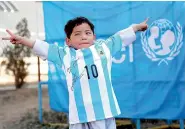  ?? — AP ?? Murtaza Ahmadi, an Afghan Lionel Messi fan, shows off an autographe­d Argentine shirt the football superstar sent to him, in Kabul, Afghanista­n, on Thursday.