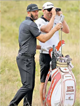  ??  ?? Looking for birdies: Dustin Johnson with his caddie and brother Austin