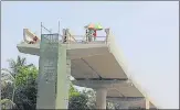  ??  ?? Labourers work on the Metro-7 line on western express highway in Dahisar.