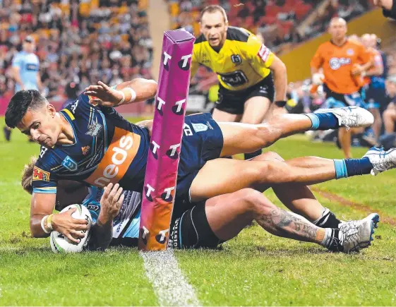  ?? Picture: BRADLEY KANARIS/GETTY ?? Jesse Arthars is denied a try on his Titans debut against Cronulla Sharks at Suncorp Stadium on Thursday night.