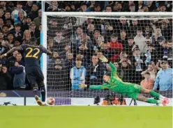  ?? Associated Press ?? ↑
Manchester City’s goalkeeper Ederson (right) fails to save the ball as Real Madrid’s Antonio Rudiger scores the winning penalty in Manchester, England, on Wednesday.