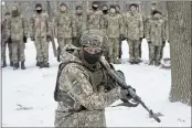  ?? EFREM LUKATSKY — THE ASSOCIATED PRESS ?? An instructor trains members of Ukraine’s Territoria­l Defense Forces, volunteer military units of the Armed Forces, in a city park in Kyiv, Ukraine. Dozens of civilians have been joining Ukraine’s army reserves in recent weeks amid fears about Russian invasion.