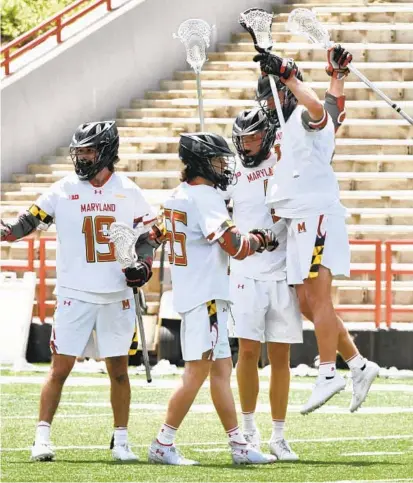  ?? AMY DAVIS/BALTIMORE SUN ?? From left, Maryland’s Keegan Khan (19), Owen Murphy (55), Logan Wisnauskas (1) and Bubba Fairman (2) celebrate after the Terps take a 9-1 lead against Vermont. The top-ranked Terps cruised to a 21-5 win in College Park on Sunday to advance to the NCAA Tournament quarterfin­als.