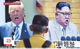  ?? AP ?? A man watches a TV screen showing file footage of US President Donald Trump and North Korean leader Kim Jong-un during a news program at a railway station in South Korea yesterday.