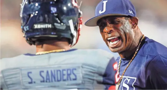  ?? HENRY TAYLOR / COMMERCIAL-APPEAL ?? Jackson State head coach Deion Sanders yells at Jackson State safety Shilo Sanders (21) on the sideline in the Southern Heritage Classic between Tennessee State University and Jackson State University at Liberty Bowl Memorial Stadium in Memphis, Tenn., on Saturday, Sept. 11, 2021.