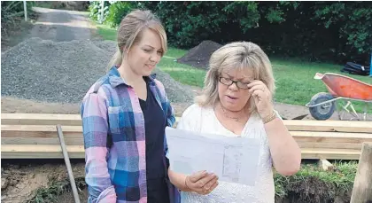  ??  ?? Karen Frankle (left) and her mother, Robyn Schreuder, check plans for their new deck on the set of Our First Home.