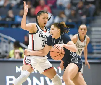  ?? JESSICA HILL/AP ?? Georgetown’s Kelsey Ransom tries to get around Uconn’s Azzi Fudd in the first half Jan. 15 in Hartford. Fudd’s return to the lineup is still up in the air.