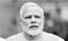  ??  ?? Modi is seen at the Parliament House in New Delhi, India. Modi will appoint nine new ministers to his cabinet in an effort to speed up developmen­t work as he comes under pressure to deliver on election promises in the final 20 months of his term. —...