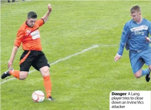  ??  ?? Danger A Lang player tries to close down an Irvine Vics attacker