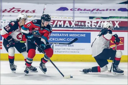  ?? ALLEN DOUGLAS/Special ?? Kelowna Rockets forward Scott Cousins dekes the Prince George Cougars defence on his way to a scoring chance on Saturday night in Kamloops during WHL action. Kelowna won 7-5.