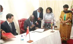  ?? ?? First Lady Amai Mnangagwa and Minister of Defence and War Veterans Affairs Oppah Muchinguri-Kashiri look on while Local Government and Public Works Minister July Moyo and Chinese Ambassador to Zimbabwe Guo Shaochun (left) sign the certificat­es at the State House in Harare yesterday.