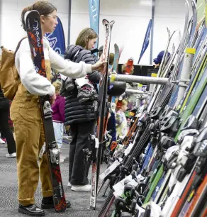  ?? PHOTO: TRACEY ROXBURGH ?? Bargainhun­ting . . . Emalee Watson, who has just moved to Queenstown from the United States, eyes up skis during yesterday’s Whakatipu Ski Club Sale at the Queenstown Events Centre.