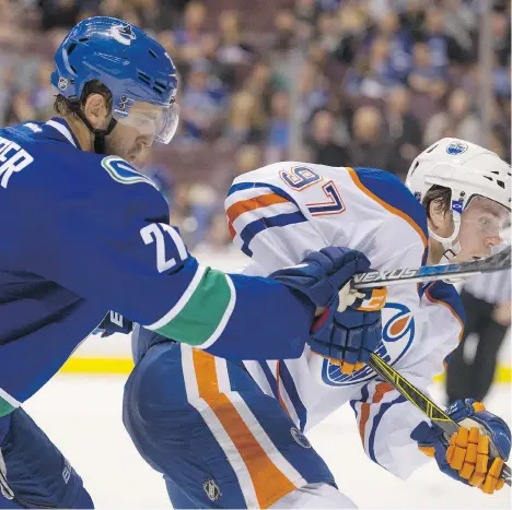  ?? GERRY KAHRMANN/FILES ?? Canucks centre Brandon Sutter, left, was asked to shut down Connor McDavid in Saturday’s game against the Oilers.