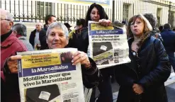  ??  ?? MARSEILLE: Journalist­s of the left-wing newspaper “La Marseillai­se”, founded during the Resistance, show copies of the newspaper as they gather outside the courthouse in Marseille yesterday during a closed hearing of the daily newspaper. The judges...