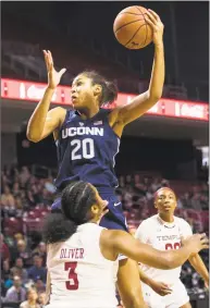  ?? Chris Szagola / Associated Press ?? UConn’s Olivia Nelson-Ododa, top, pulls down the rebound over Temple’s Desiree Oliver.