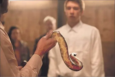  ?? 1091 Media ?? WALTON GOGGINS plays a snake-handling pastor and Thomas Mann is a young man who has left the church in “Them That Follow.”