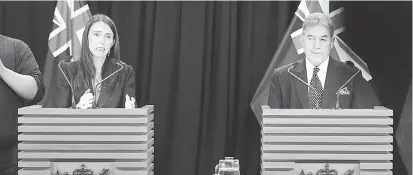  ?? — Gambar AFP ?? TEGAS: Ardern (kiri) bercakap kepada media di sebelah menteri luar negeri Winston Peters semasa sidang media selepas mesyuarat kabinet di parlimen di Wellington, New Zealand pada Isnin.