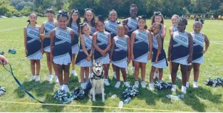  ?? KEITH GROLLER/THE MORNING CALL ?? East Side Youth Center youth football cheerleade­rs gather around Kiska VI, who is the mascot for Dieruff High athletic teams and the East Side Youth Center youth football program.