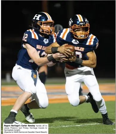  ?? (Special to NWA Democrat-Gazette/ David Beach) ?? Rogers Heritage’s Carter Hensley hands off to Jesse Polanco last Friday. Heritage travels to Springdale tonight.